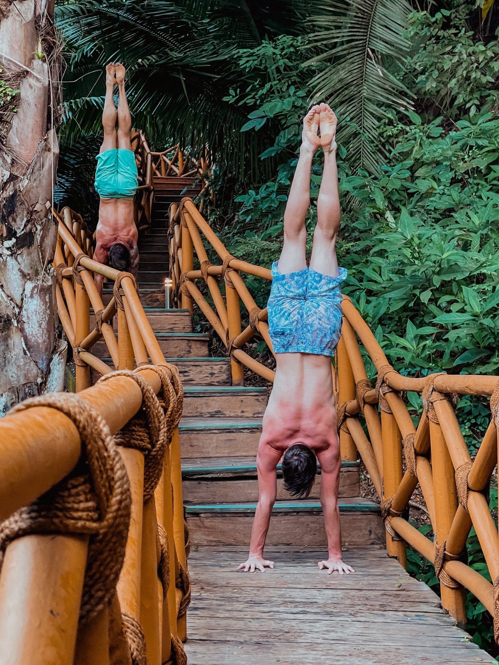 David and Avery Johnson holding handstands side by side
